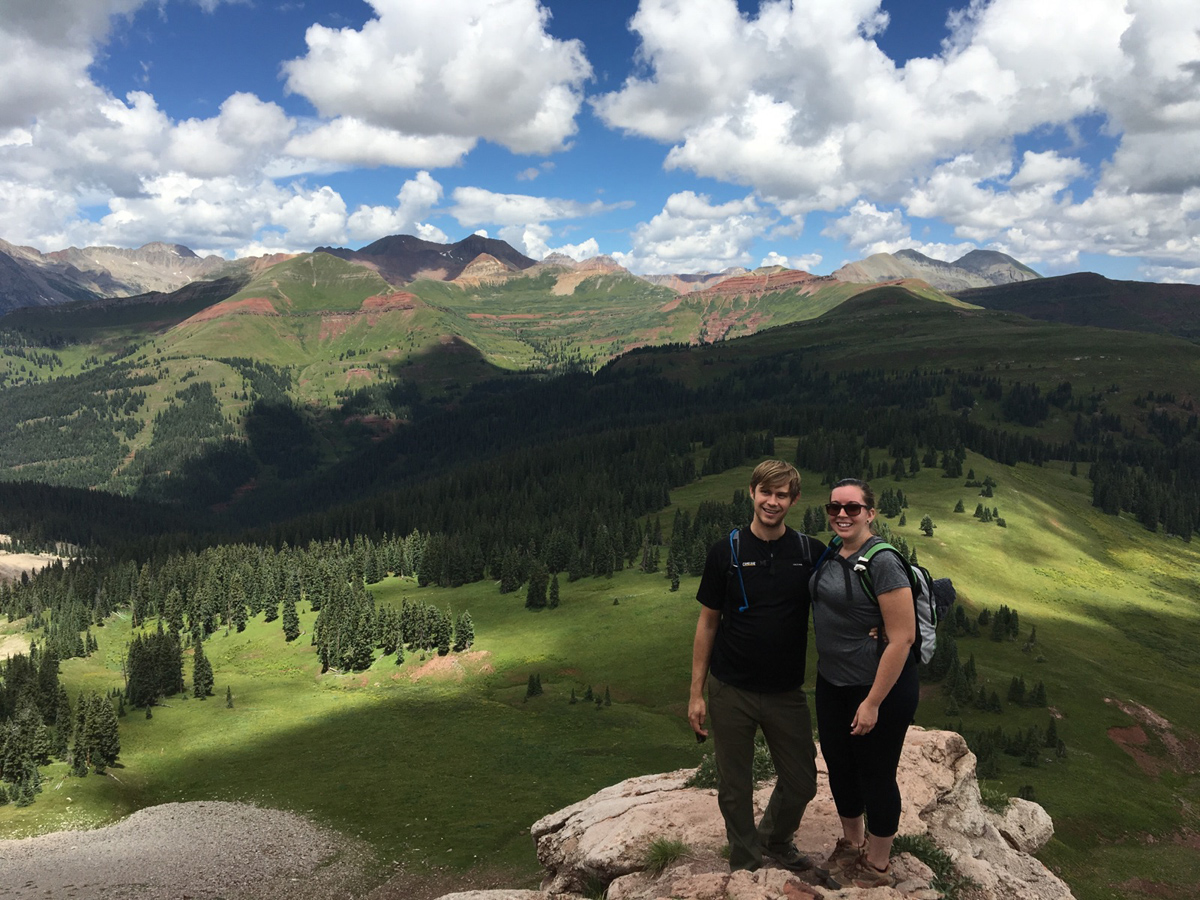 Jamison and Kelsie standing on a mountain in Colorado